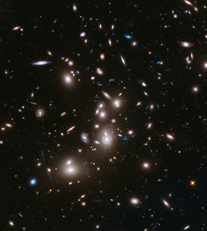 The immense gravity in this foreground galaxy cluster, Abell 2744, warps space to brighten and magnify images of far-more-distant background galaxies as they looked over 12 billion years ago, not long after the big bang.  This is the first of the Frontier Fields to be imaged.