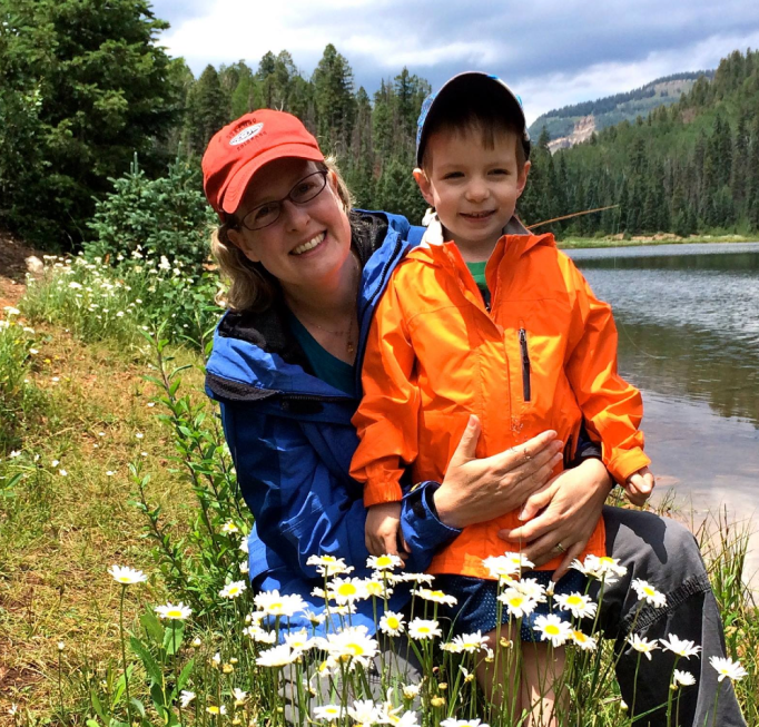 This picture shows Jennifer Mack enjoying time  with her son in a field in Colorado.