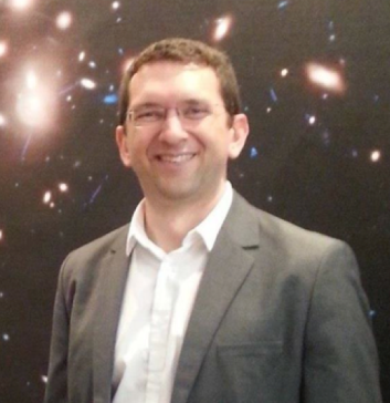 Dan Coe, ESA/AURA Astronomer, in front of the first Frontier Fields image, Abell 2744.