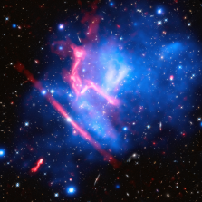 Shown here are observations of the Frontier Fields galaxy cluster MACS J0717, taken by Chandra, Hubble, and the Jansky Very Large Array. Diffuse blue colors (Chandra X-ray Observatory) are from the light emitted by gas with temperatures of millions of degrees. Red, green, and blue (Hubble Space Telescope) colors are from galaxies. Diffuse pink colors (Jansky Very Large Array) are from excited gas from shock waves and turbulence due to merging galaxy clusters (middle-top and lower-left), as well as a foreground radio galaxy (center left). Credit: NASA, ESA, CXC, NRAO/AUI/NSF, STScI, and R. van Weeren (Harvard-Smithsonian Center for Astrophysics)